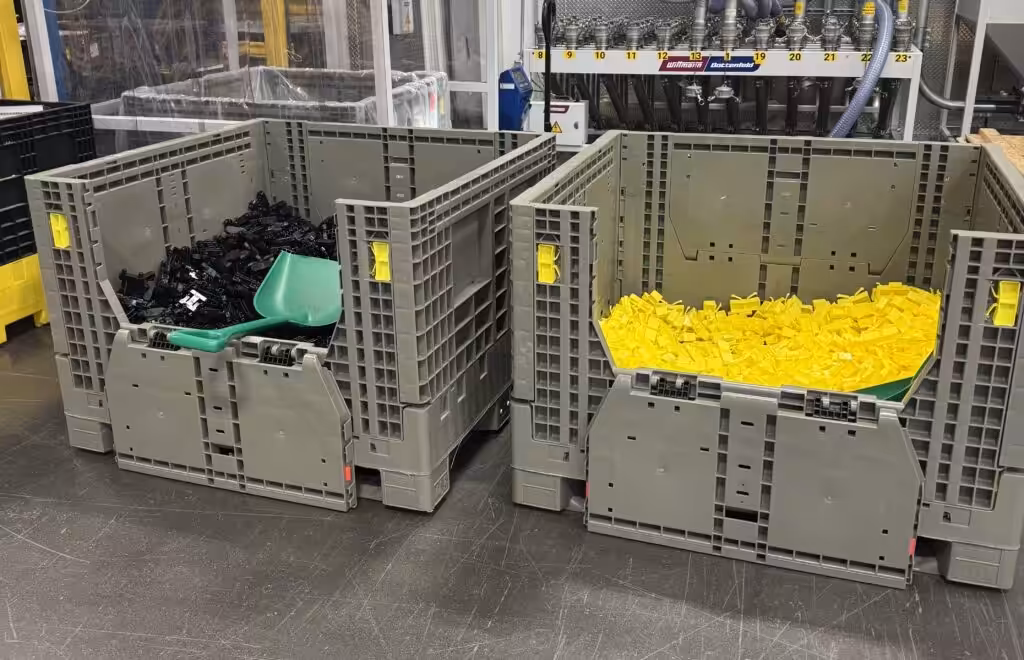 Bulk containers filled with components on a warehouse floor