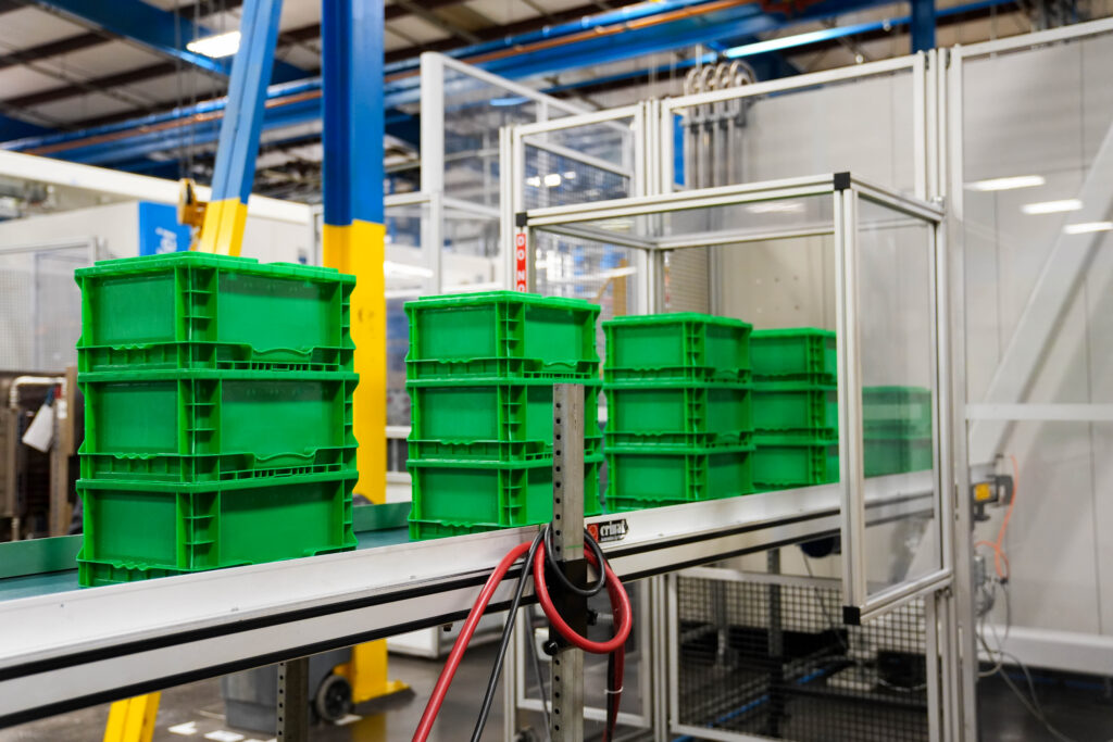 Straight wall totes being manufactured in a warehouse.