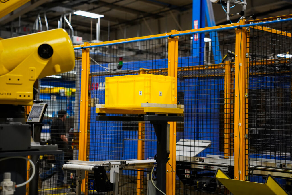 Yellow automation bin inside an automated production cell.