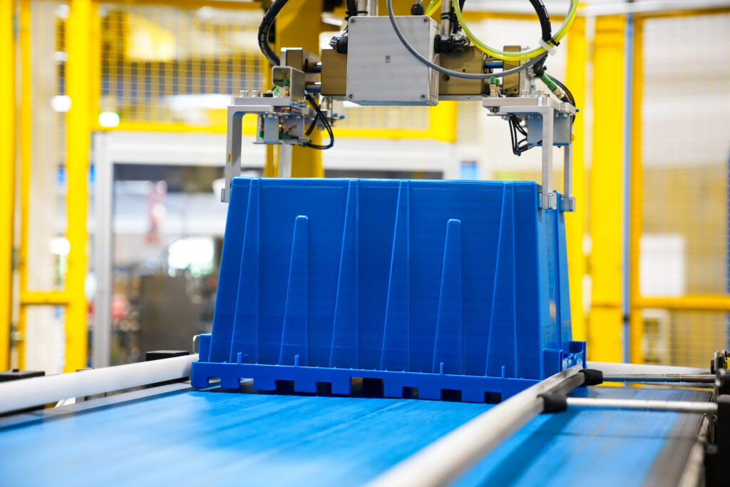 Reusable plastic tote in an automated production cell.